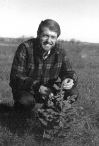 Neal Smith checks one of the new trees planted in our Conservation Reserve Program (circa 1987).