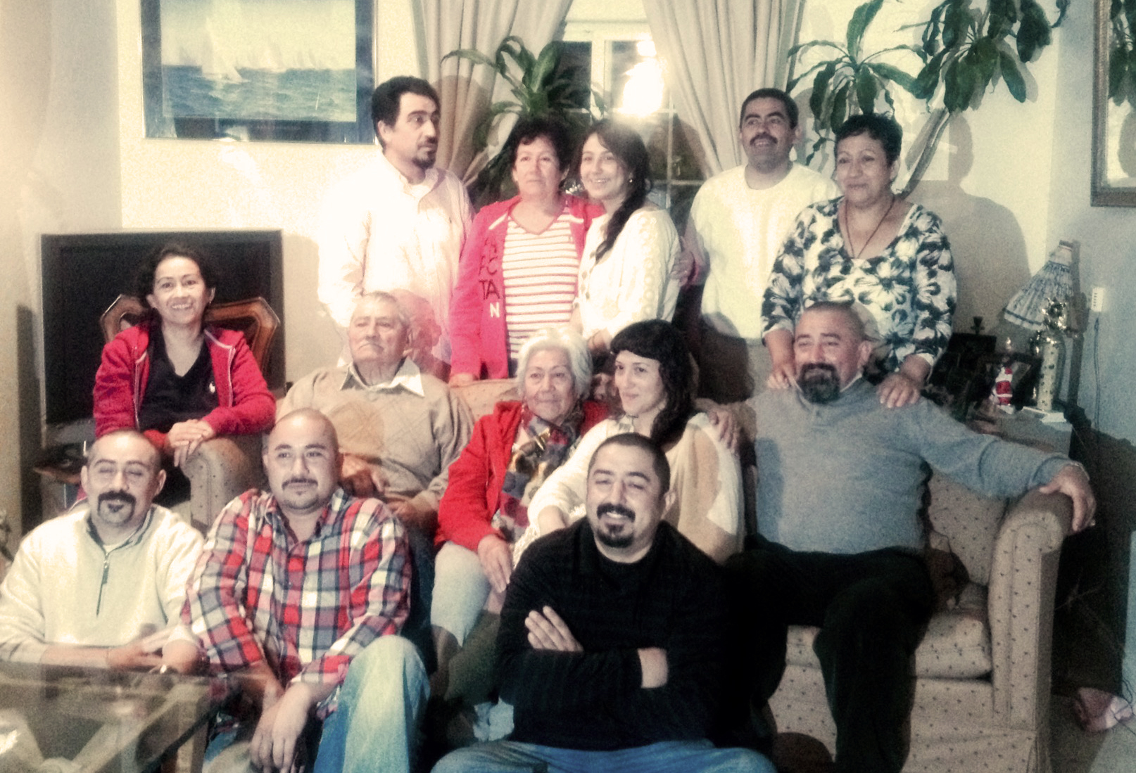 Paz (middle row, left) with her parents, 6 brothers, 2 sisters and 2 nieces, Christmas 2014