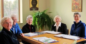 Sisters gathered around a table with work at hand