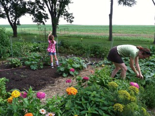 Sherri Hansen gardens with her niece Cadia Rose in their main farm garden in Sauk Prairie, Wisconsin.