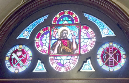 Image of St John in stained glass window