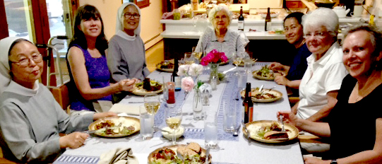 Sisters and guests seated around the dinner table